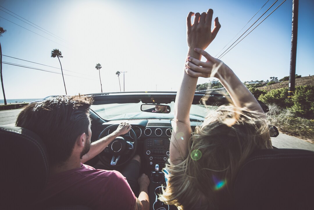 Shutterstock 566975464 Couple Driving On A Convertible Car