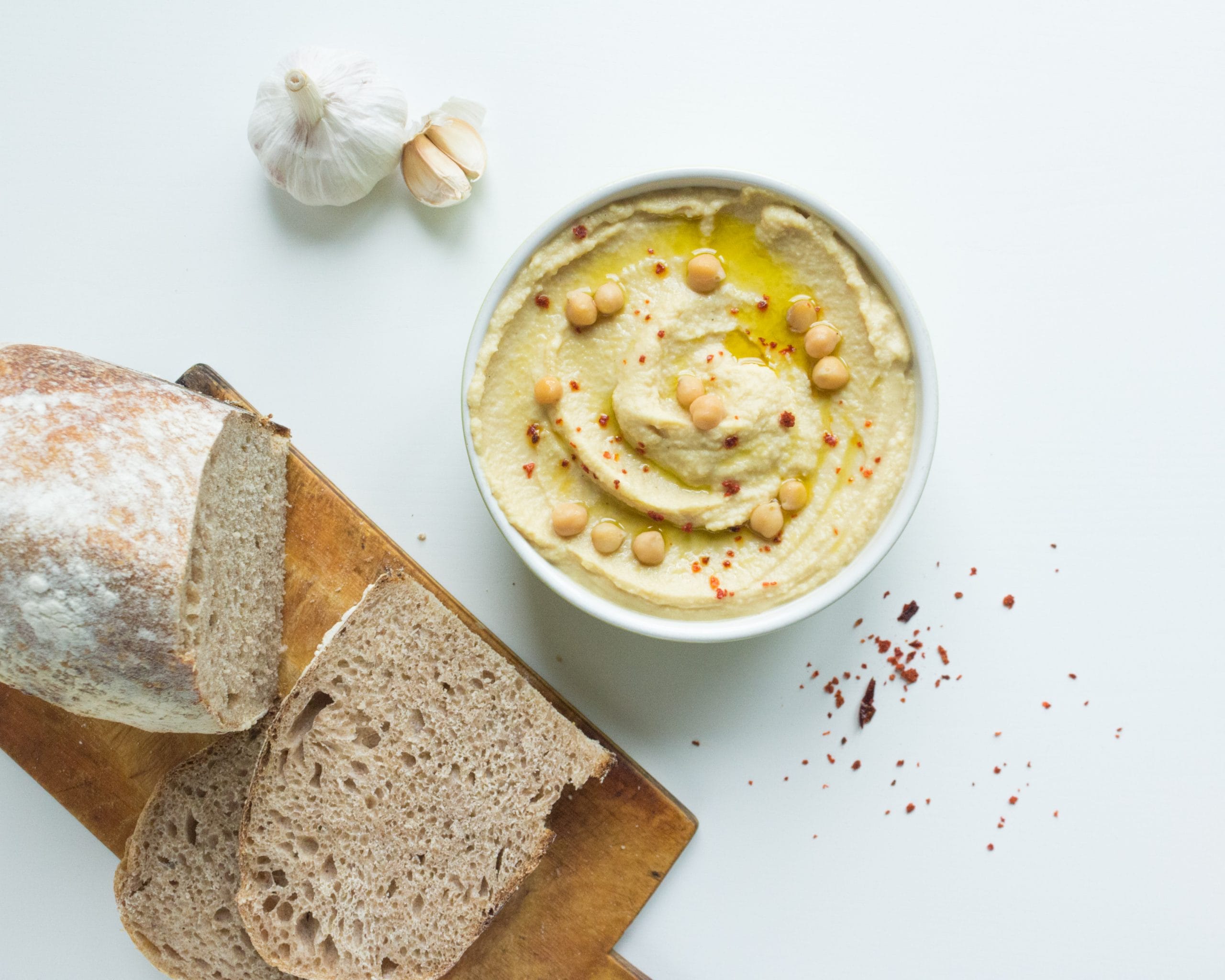 This internationally popular, beige-coloured spread is traditionally made with mashed chickpeas, sesame paste, lemon juice, and garlic. The earliest mention of this tangy flavoured and highly nutritious dish dates back to 13th-century Egypt. When served, it is typically dressed with a drizzle of olive oil, and is then used as a dip for vegetables or a flavourful filling for flatbreads. 