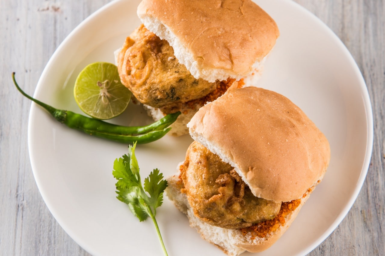 Who invented the mouth-watering Maharashtrian street food Vada Pav and in which year?
